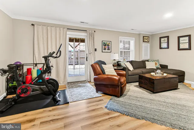 a living room with furniture a rug and a window