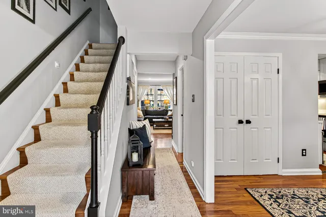 a view of hallway with wooden floor and stairs