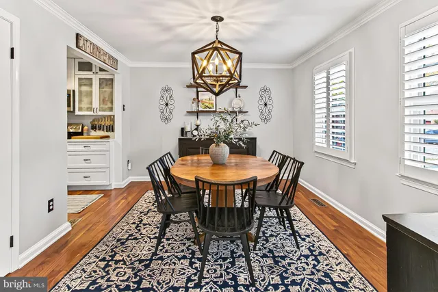 a dining room with furniture window and wooden floor