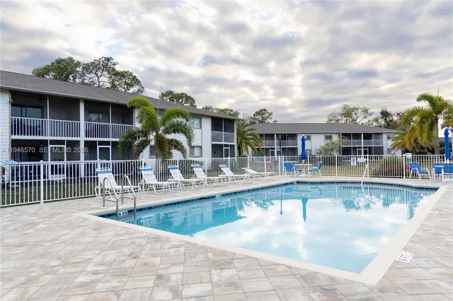 a view of house with swimming pool and furniture