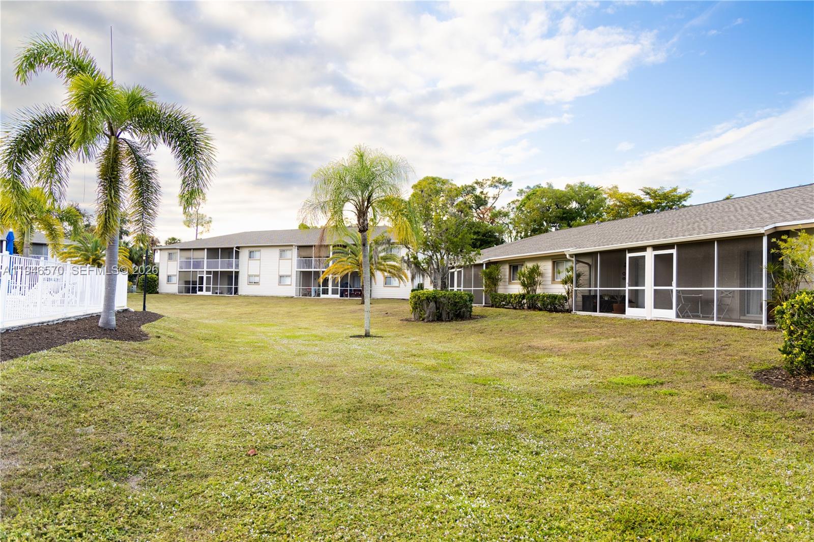 2385 Naples Trace Circle, Unit 5 Naples, FL 34109 - Photo 12 of 13 a front view of a house with a garden