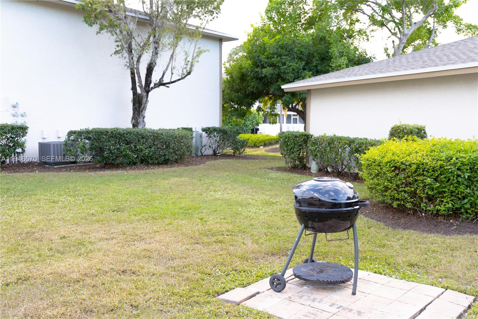 2385 Naples Trace Circle, Unit 5 Naples, FL 34109 - Photo 13 of 13 a front view of a house with garden