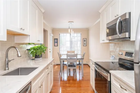 a kitchen with a stove a sink and a microwave