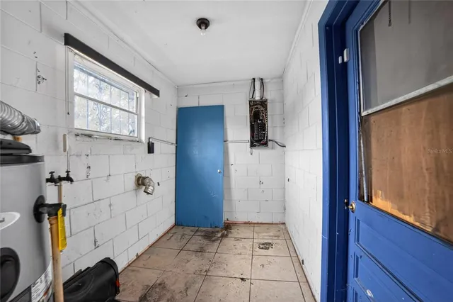 a view of a hallway with bathroom and front door