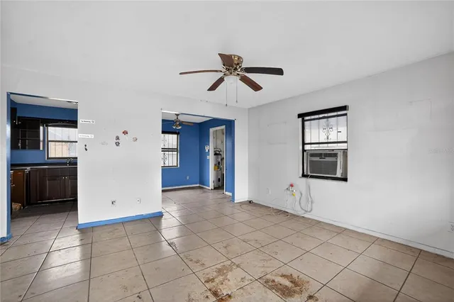 an empty room with closet and a chandelier fan