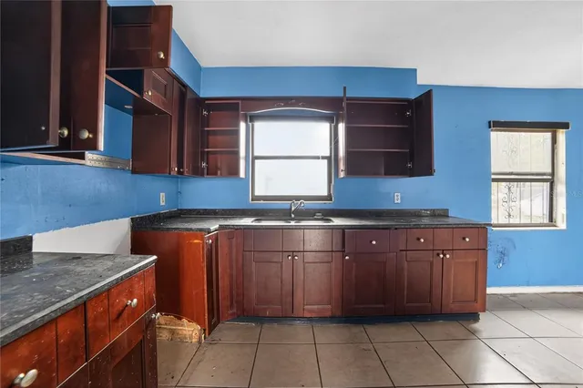 a kitchen with granite countertop a sink and a stove