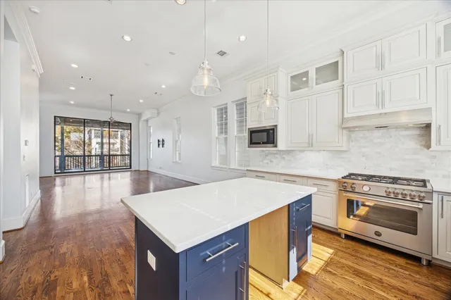a kitchen with a stove a sink and a refrigerator