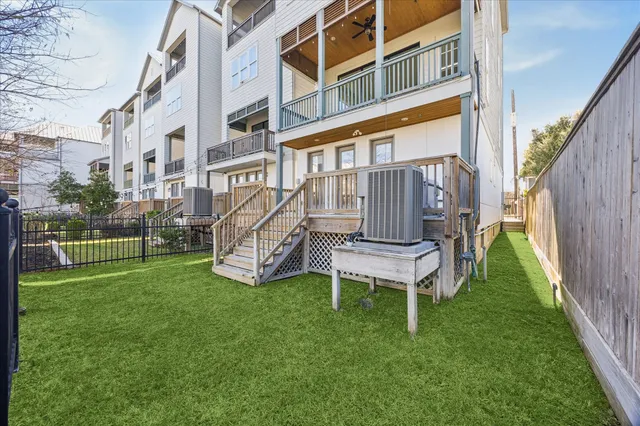 a view of a chair in a yard with wooden fence