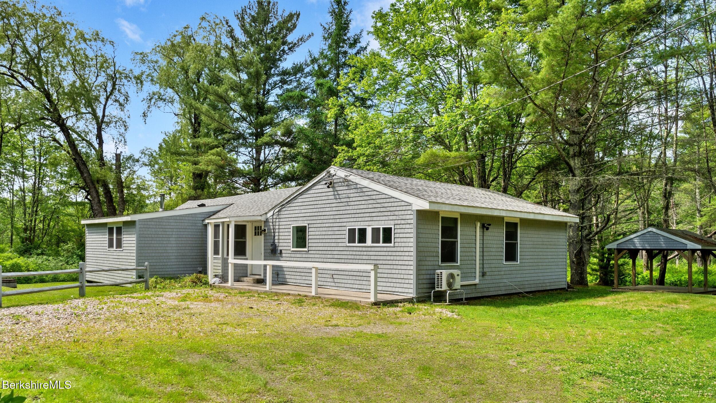 a view of a house with a backyard
