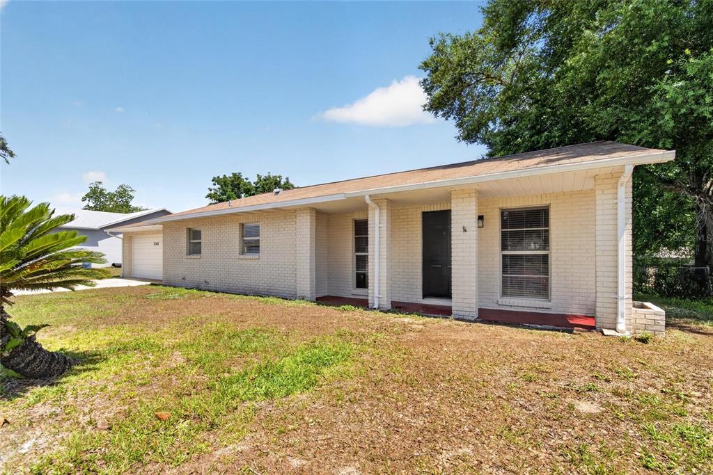 2340 Merrily Circle South Seffner, FL 33584 - Photo 3 of 52 a front view of house with yard and trees in the background