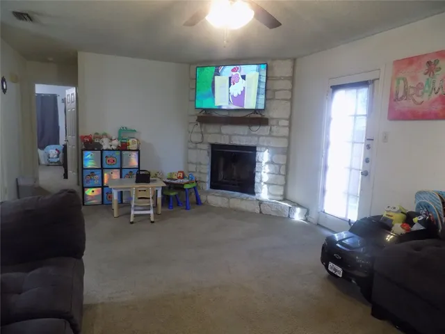 a living room with furniture and a fireplace