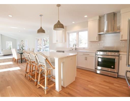 815 Main Street Acton, MA 01720 - Photo 6 of 27 a kitchen with stainless steel appliances kitchen island a stove a sink cabinets and a wooden floor