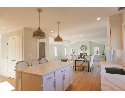 815 Main Street Acton, MA 01720 - Photo 8 of 27 a kitchen with stainless steel appliances granite countertop a stove a sink a dining table and chairs with wooden floor