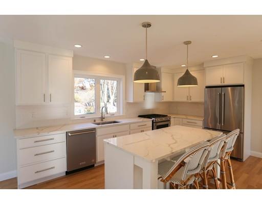 815 Main Street Acton, MA 01720 - Photo 9 of 27 a kitchen with stainless steel appliances kitchen island a stove a sink dishwasher a refrigerator and white cabinets with wooden floor