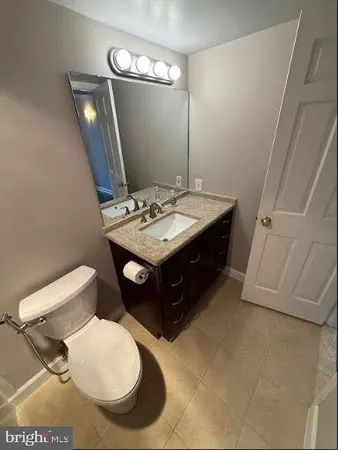 a bathroom with a sink vanity and toilet
