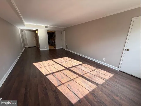 a view of a room with wooden floor and staircase