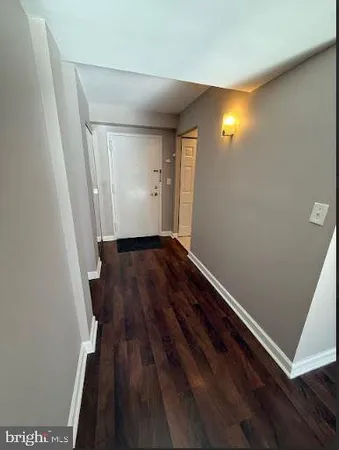 wooden floor in a hall with an empty room