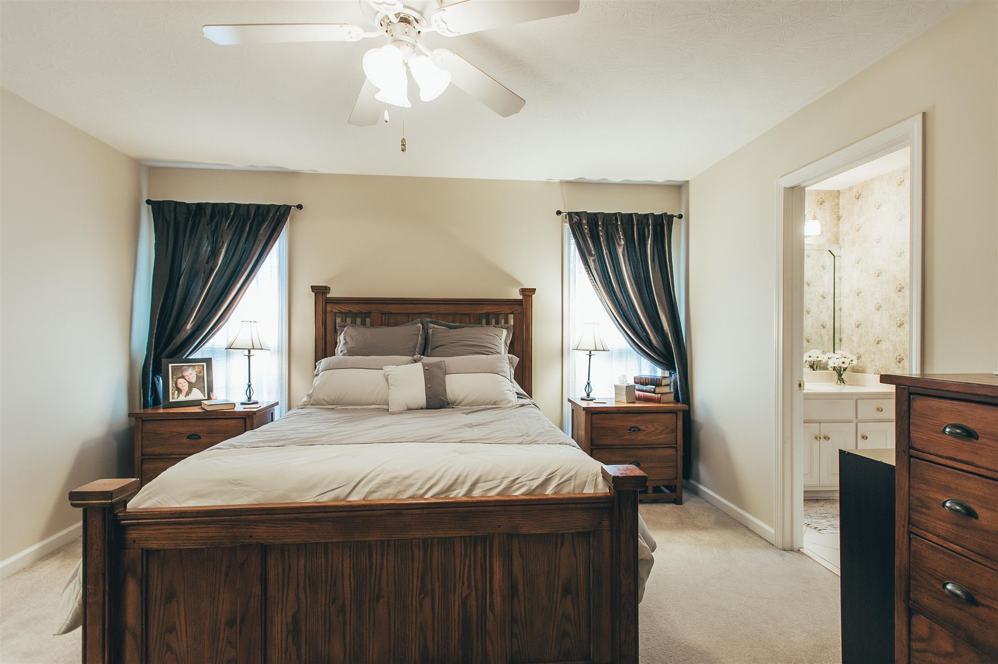 134 Abbey Road Gallatin, TN 37066 - Photo 11 of 18 a bedroom with a large bed and a chandelier