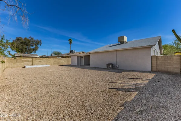 a view of a house with a backyard