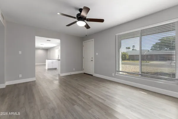 a view of a livingroom with a ceiling fan and window