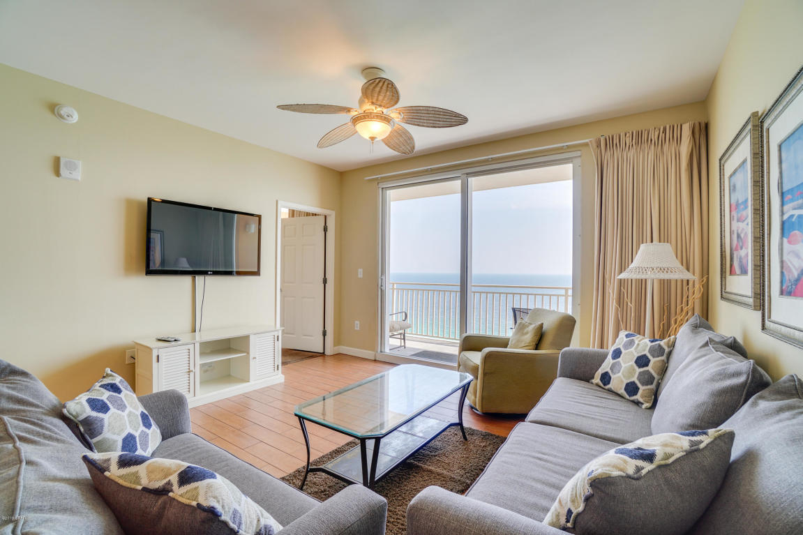 17739 Front Beach Road, Unit 1902W Panama City Beach, FL 32413 - Photo 1 of 30 a living room with furniture a large window and a flat screen tv