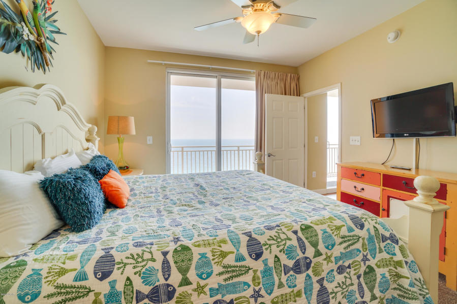 17739 Front Beach Road, Unit 1902W Panama City Beach, FL 32413 - Photo 11 of 30 a bedroom with a bed and flat screen tv
