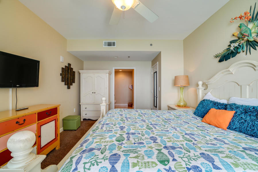 17739 Front Beach Road, Unit 1902W Panama City Beach, FL 32413 - Photo 14 of 30 a bedroom with a bed and flat screen tv