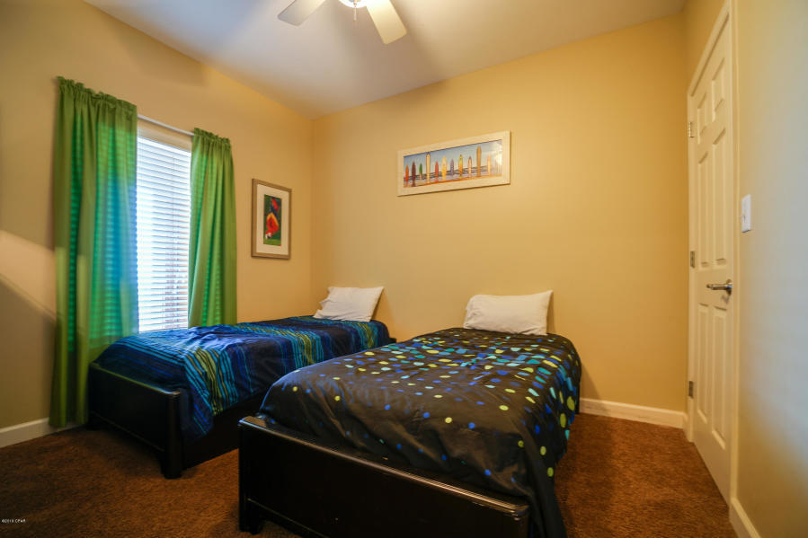 17739 Front Beach Road, Unit 1902W Panama City Beach, FL 32413 - Photo 15 of 30 a bedroom with two beds and a window