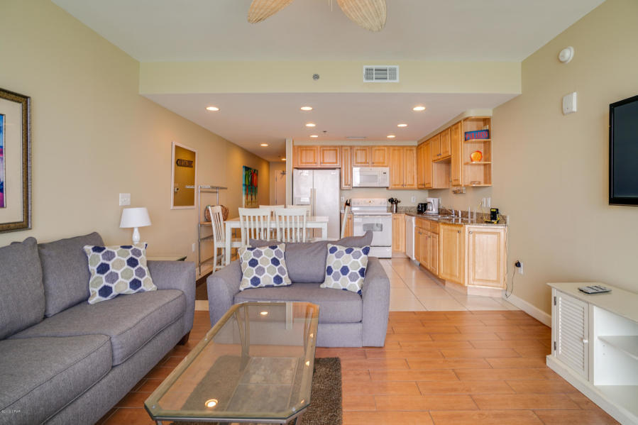 17739 Front Beach Road, Unit 1902W Panama City Beach, FL 32413 - Photo 6 of 30 a living room with furniture and kitchen view