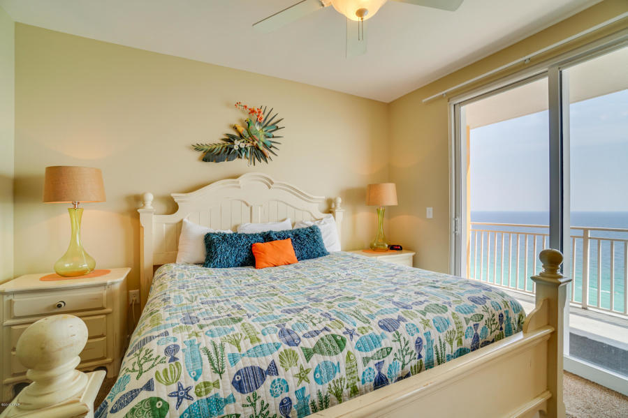 17739 Front Beach Road, Unit 1902W Panama City Beach, FL 32413 - Photo 10 of 30 a bedroom with a bed and wooden floor