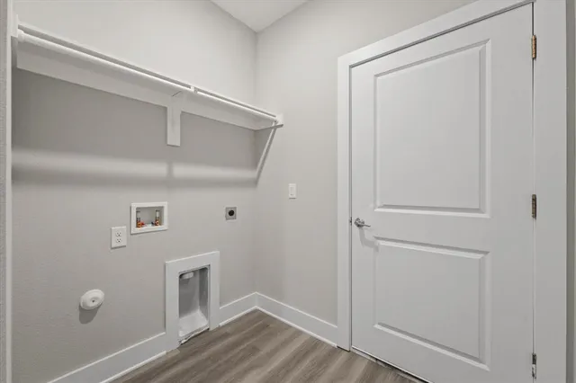 a kitchen with a sink and wooden floor