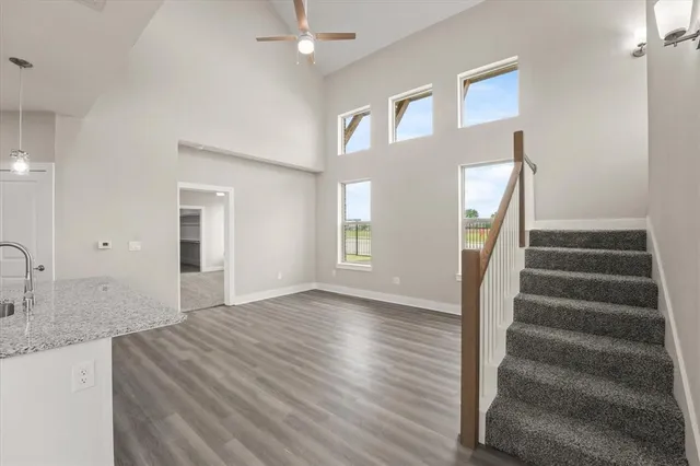 a view of an entryway with wooden floor and staircase
