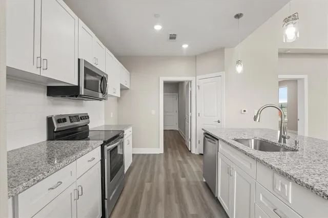 a view of a room with wooden floor and windows