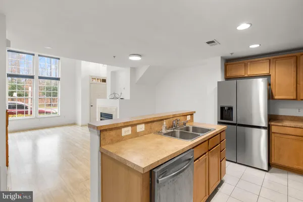 a view of kitchen with stainless steel appliances a refrigerator and microwave