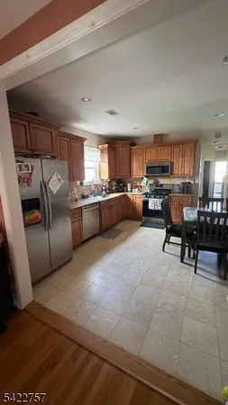 a kitchen with a refrigerator and a counter top space