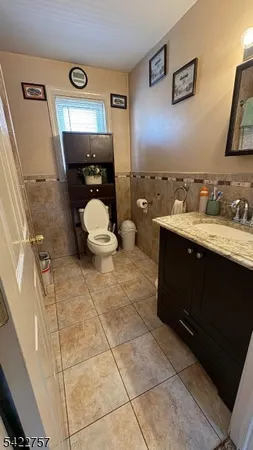 a bathroom with a sink vanity and toilet