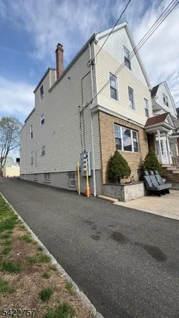 a view of a white house with a street