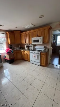 a kitchen with stainless steel appliances granite countertop a sink dishwasher stove top oven and cabinets
