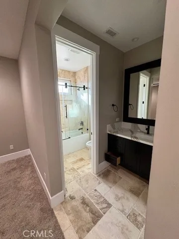 a bathroom with a double vanity sink and mirror