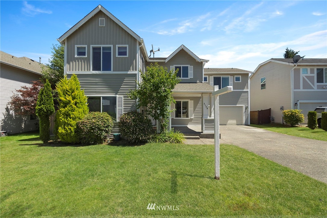 3129 Walker Road DuPont, WA 98327 - Photo 1 of 33 a front view of a house with a yard and garage
