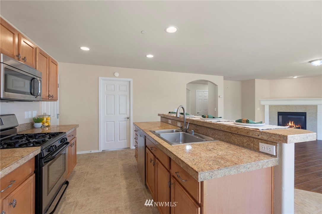 3129 Walker Road DuPont, WA 98327 - Photo 14 of 33 a kitchen with kitchen island granite countertop a sink and stove