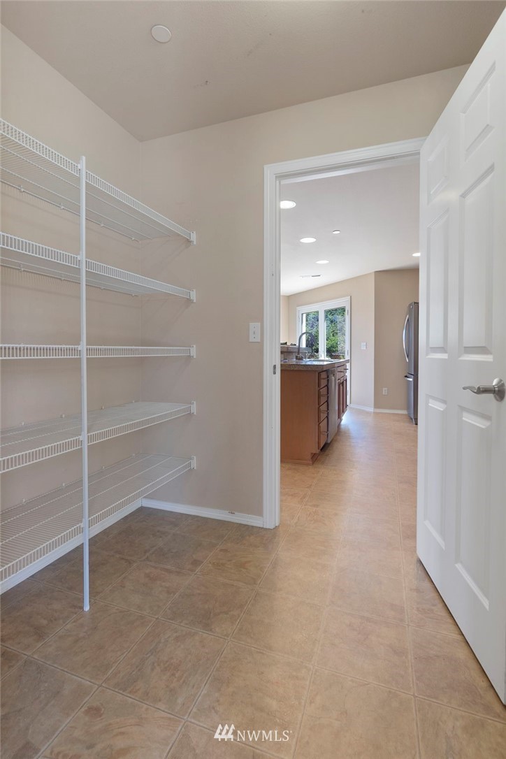 3129 Walker Road DuPont, WA 98327 - Photo 16 of 33 a view of a room with wooden shelves