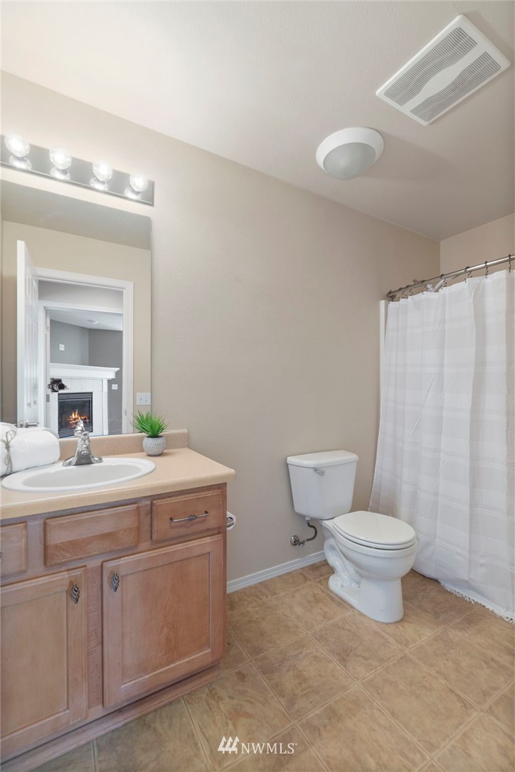 3129 Walker Road DuPont, WA 98327 - Photo 21 of 33 a bathroom with a toilet sink and mirror