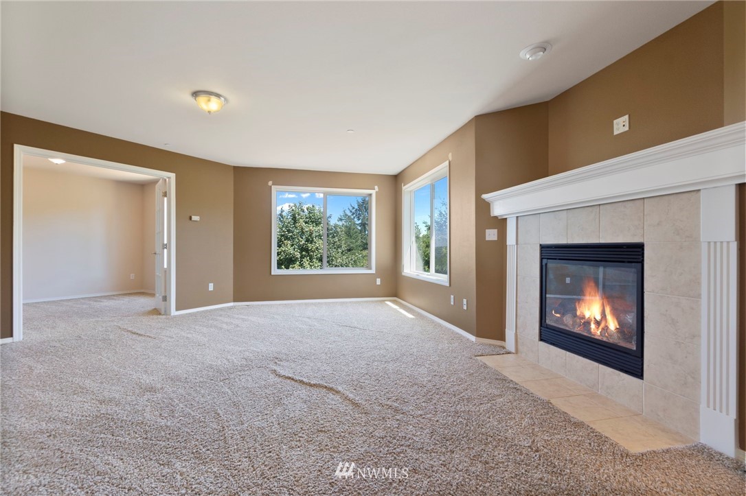 3129 Walker Road DuPont, WA 98327 - Photo 23 of 33 a view of an empty room with a window and fireplace