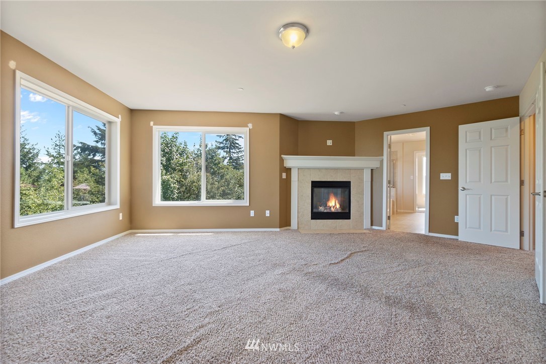 3129 Walker Road DuPont, WA 98327 - Photo 29 of 33 a view of an empty room with a window and a fireplace