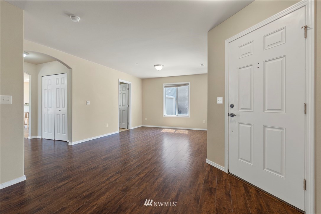 3129 Walker Road DuPont, WA 98327 - Photo 4 of 33 a view of an empty room with wooden floor and a window