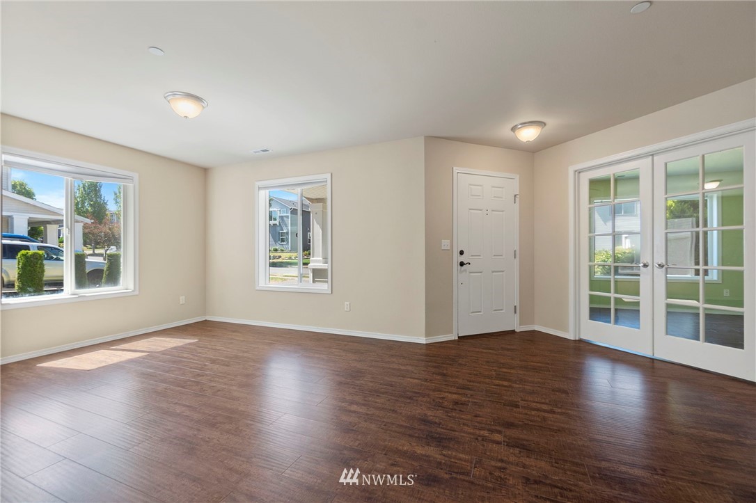 3129 Walker Road DuPont, WA 98327 - Photo 5 of 33 a view of an empty room with wooden floor and a window
