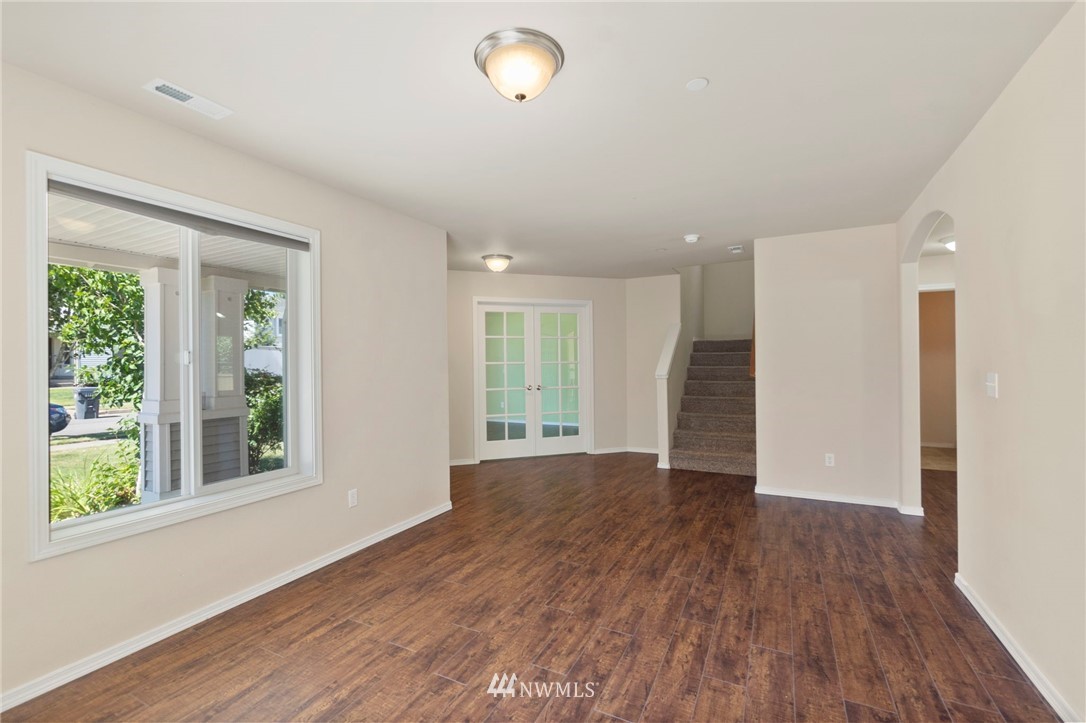 3129 Walker Road DuPont, WA 98327 - Photo 6 of 33 a view of an empty room with wooden floor and a window