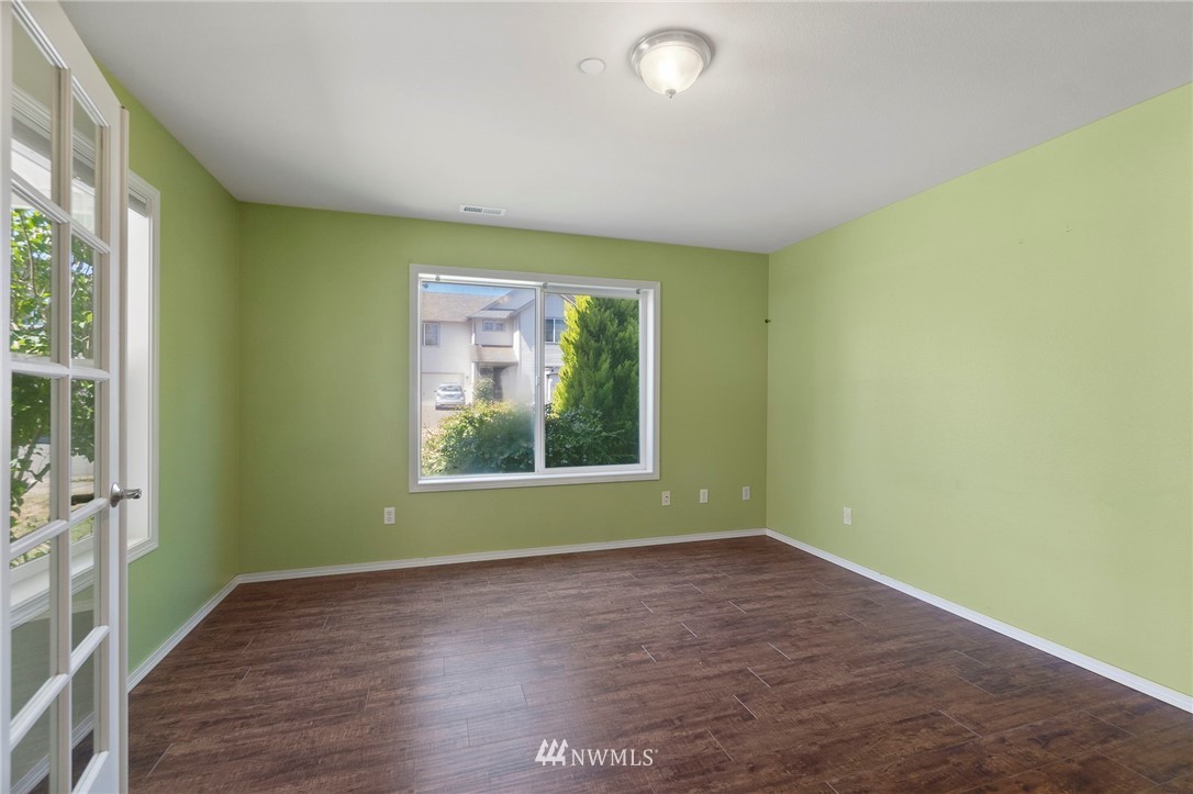 3129 Walker Road DuPont, WA 98327 - Photo 7 of 33 an empty room with wooden floor and windows