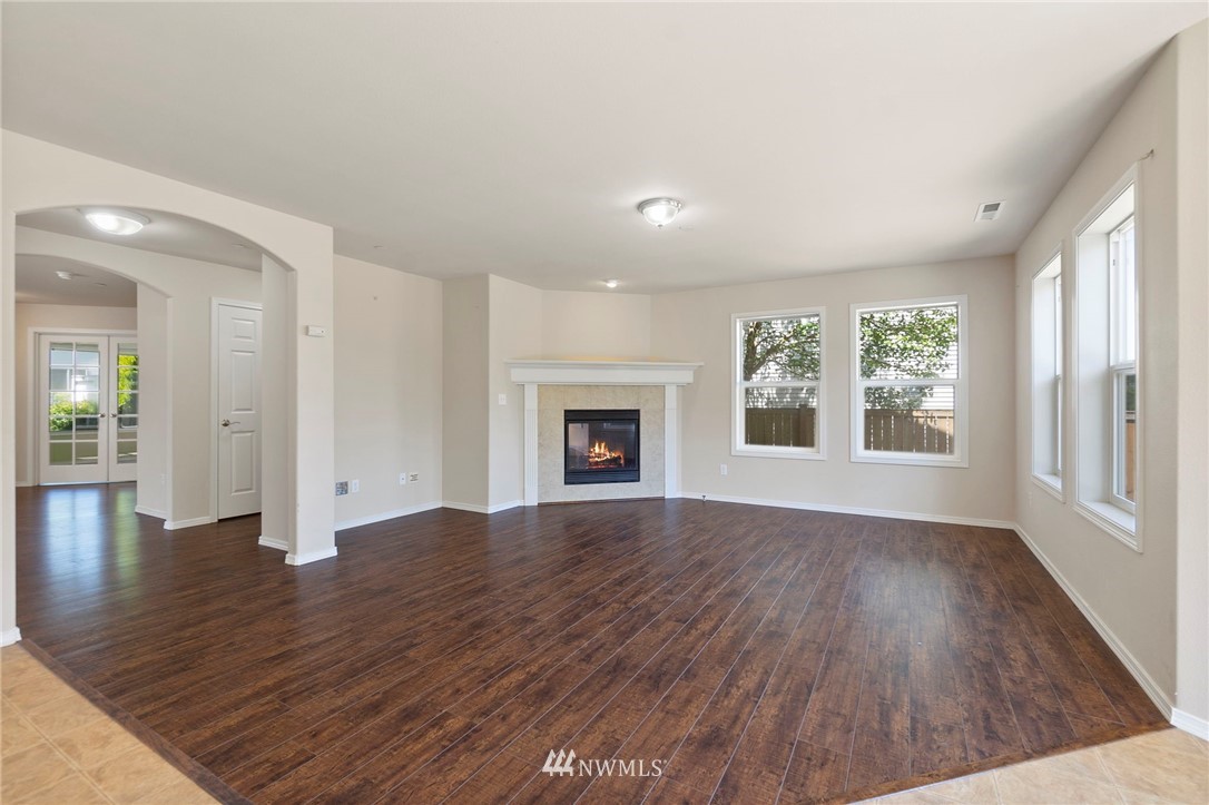3129 Walker Road DuPont, WA 98327 - Photo 10 of 33 an empty room with wooden floor and windows